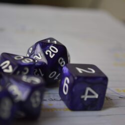 purple-and-white dices on white lined paper